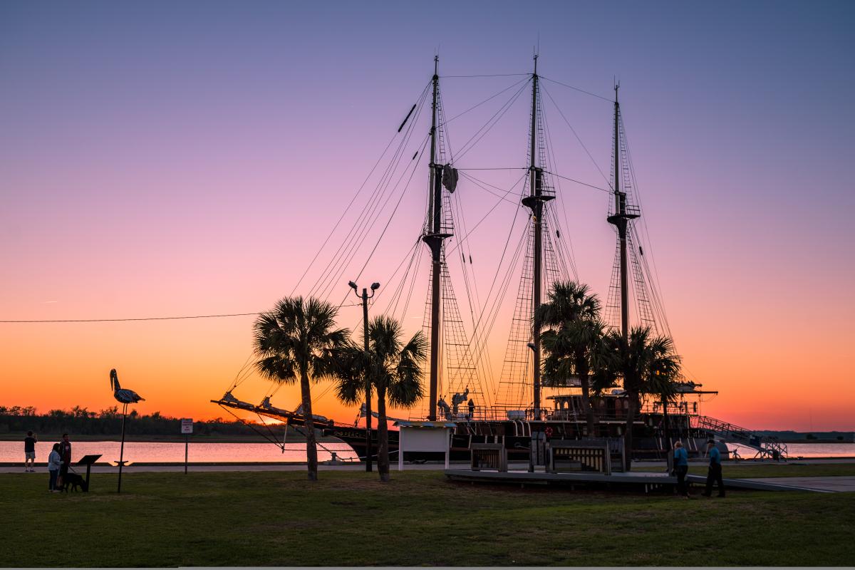 End your day marveling at a stunning sunset behind boats at <a target=